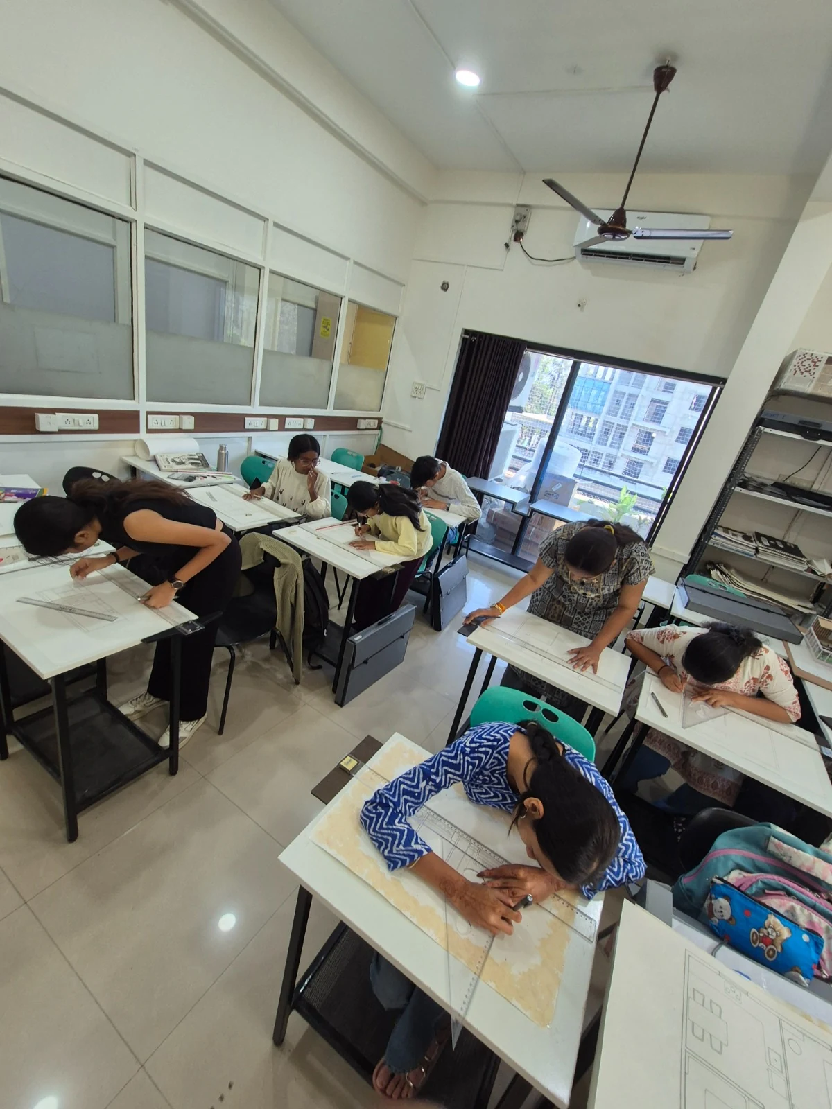 AICT Interior Design students working on drawings during a studio session