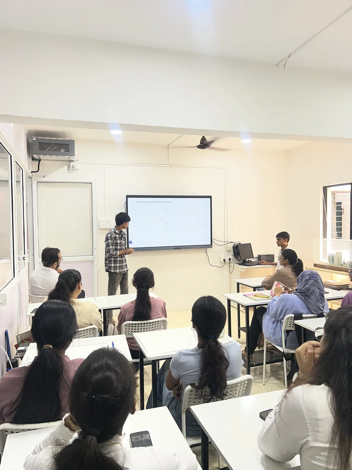 AICT student presenting design work to the classroom