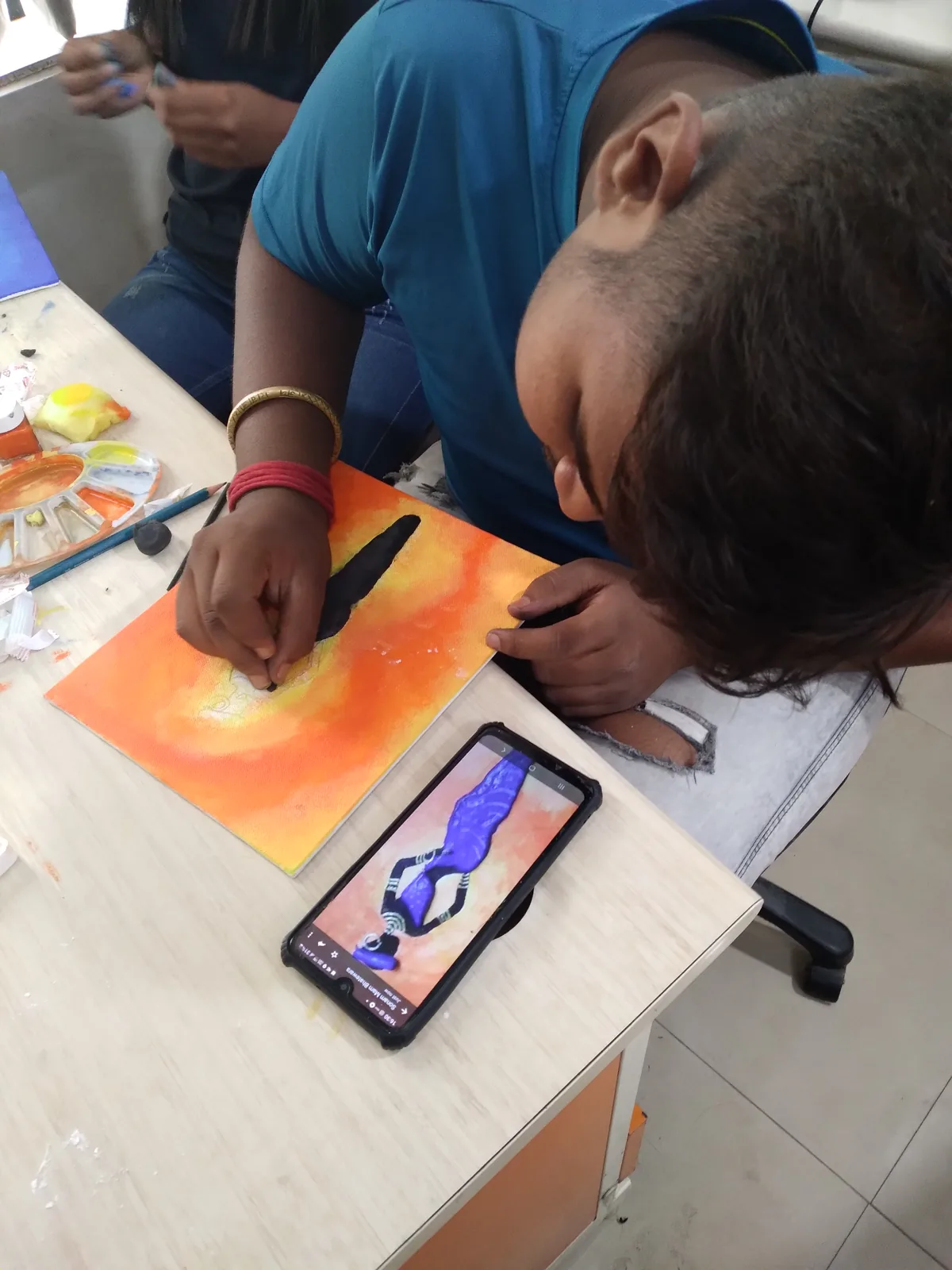 AICT student practicing canvas painting during a creative workshop